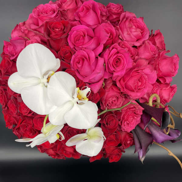 Bouquet of hot pink roses with white orchids and dark purple calla lilies