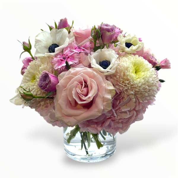 Pink and white bouquet in a clear glass vase