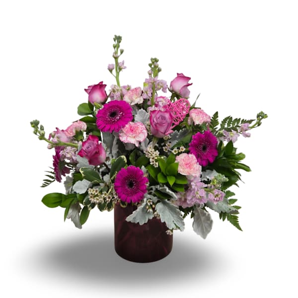Pink and magenta mixed bouquet in a dark vase
