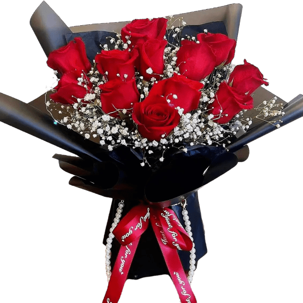 Bouquet of red roses with white baby's breath in dark wrapping