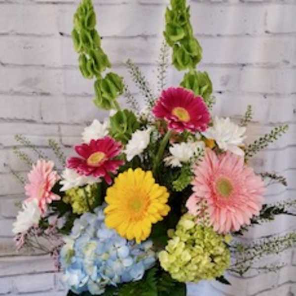 Colorful mixed flower arrangement in a glass vase