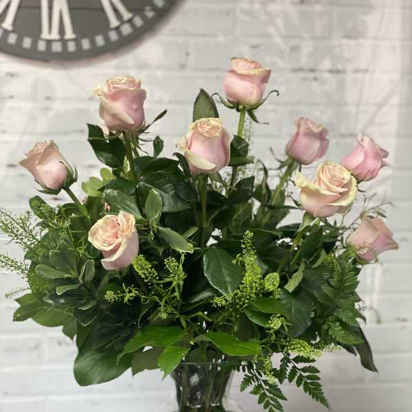 Pink roses arranged in a clear glass vase