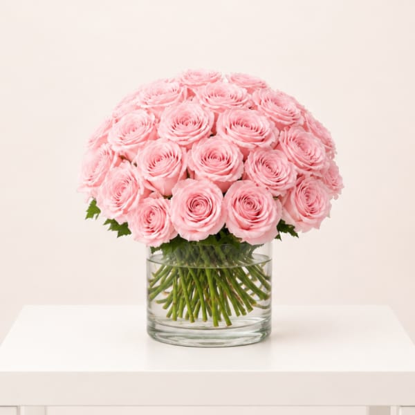 Pink roses arranged in a clear glass vase