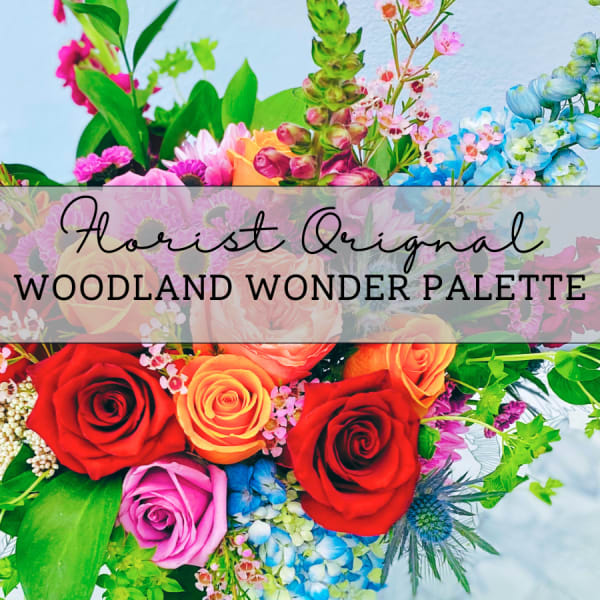 Colorful floral arrangement with roses and mixed blooms in bright pink, red, orange, and blue