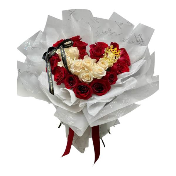 Bouquet of red and cream roses wrapped in white paper with a ribbon