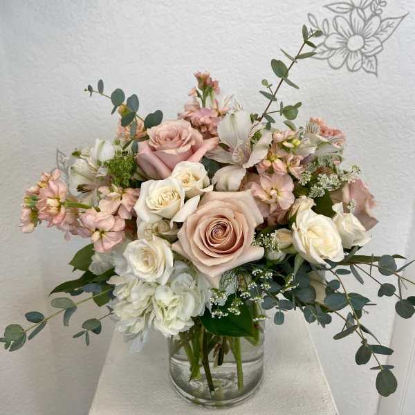 Blush and white rose bouquet in a clear glass vase