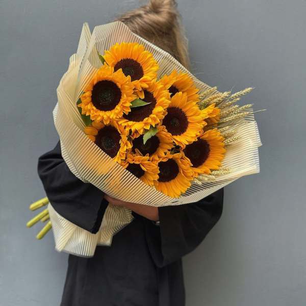 Bouquet of sunflowers wrapped in striped paper