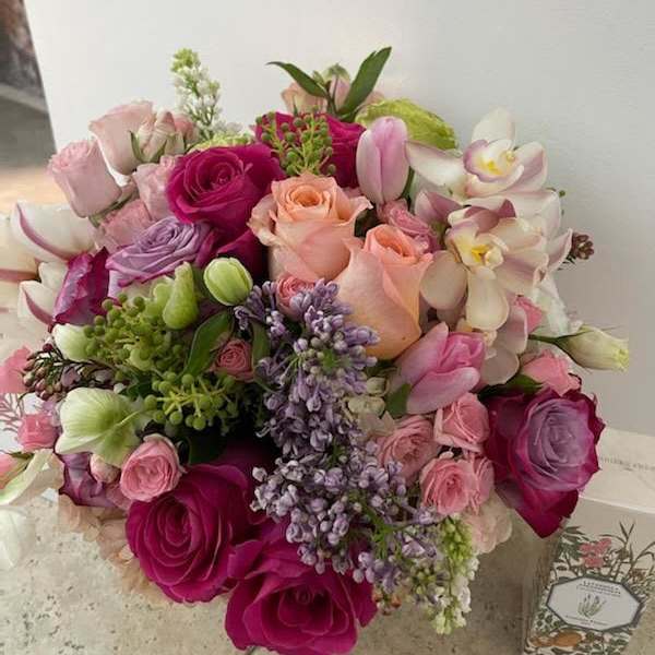 Bouquet of pink and purple roses with orchids and tulips