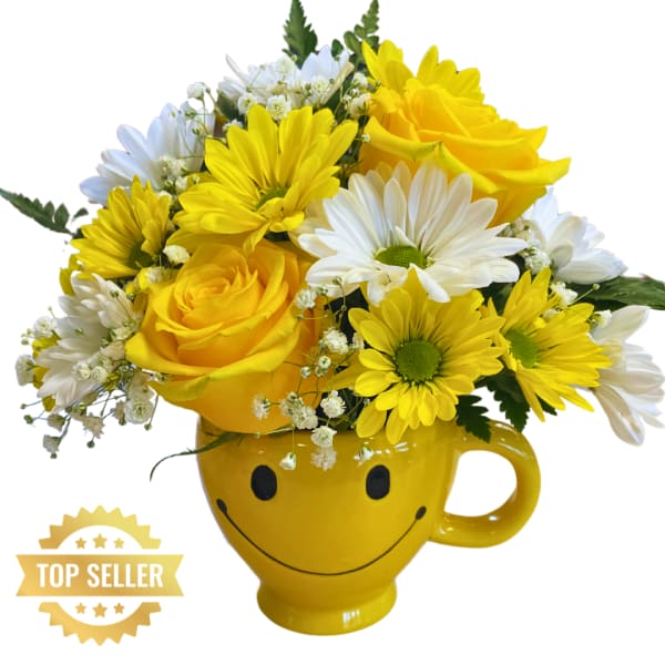 Yellow and white flower bouquet in a smiley-face mug