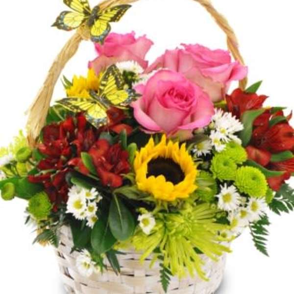 Basket of pink roses, sunflowers, and red blooms with butterfly decorations