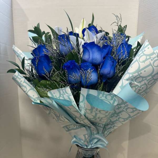 Blue roses and white lilies in a wrapped bouquet