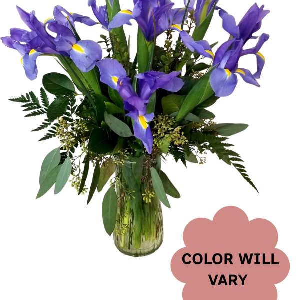 Purple iris bouquet in a clear glass vase