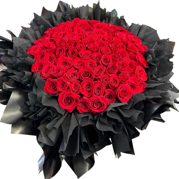 Large bouquet of red roses wrapped in black paper
