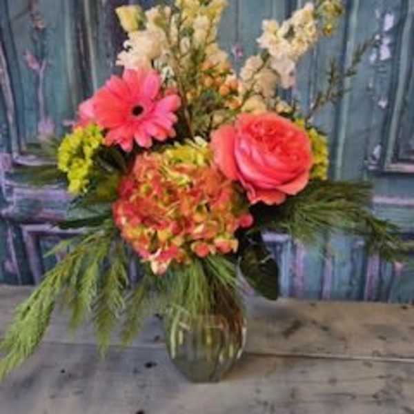 Pink gerbera and rose arrangement in a glass vase