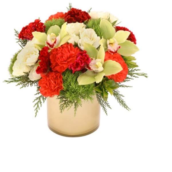 Round arrangement of red and white flowers with green orchids in a gold cylinder vase