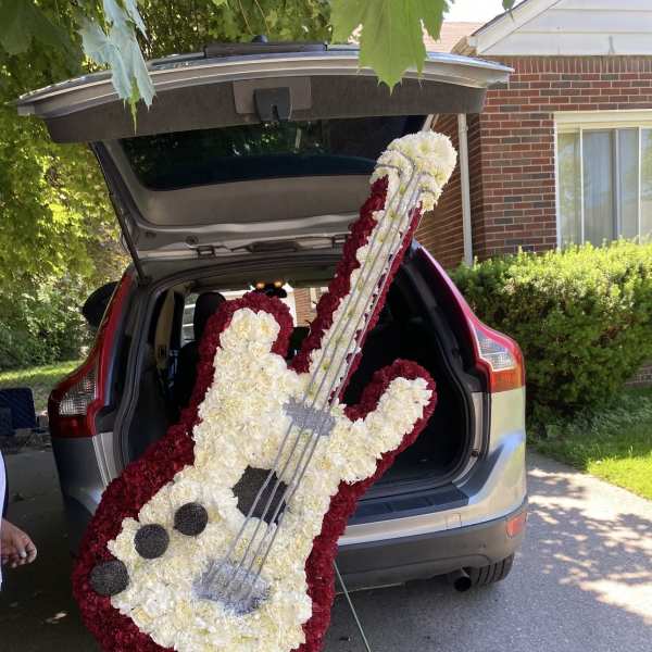Guitar-shaped floral tribute in white and burgundy flowers