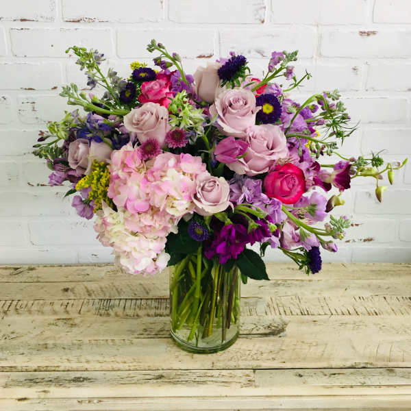 Mixed pink and purple bouquet in a clear glass vase
