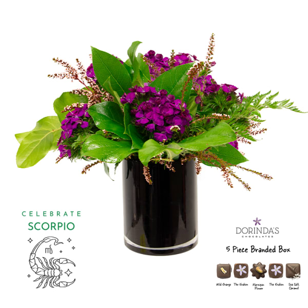 Purple floral arrangement in a black vase with a chocolate box and Scorpio graphic