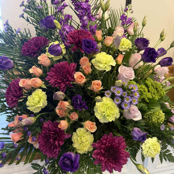 Large mixed bouquet with purple, peach, and yellow flowers