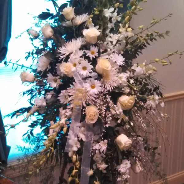 Tall floral standing arrangement with white roses and daisy-like blooms