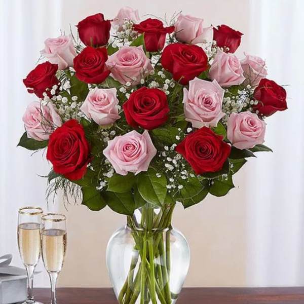 Bouquet of red and pink roses in a clear glass vase