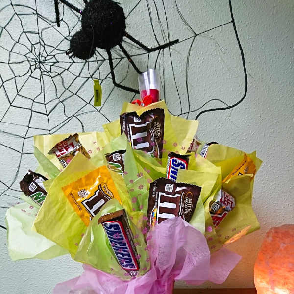 Bouquet of candy bars wrapped in pink and yellow tissue paper