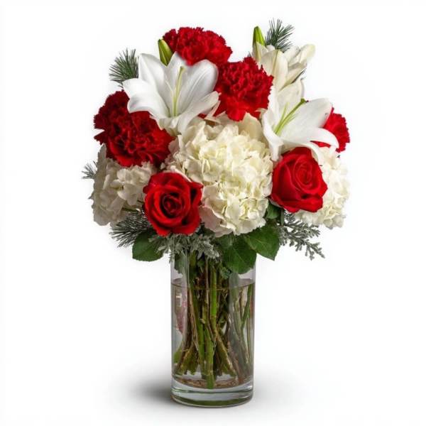 Bouquet of red roses, white lilies, and white hydrangeas in a clear glass vase