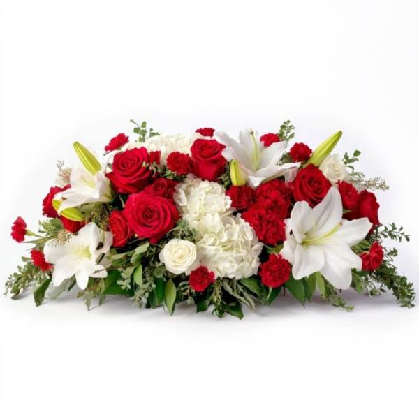 Red roses and white lilies arranged in a low centerpiece