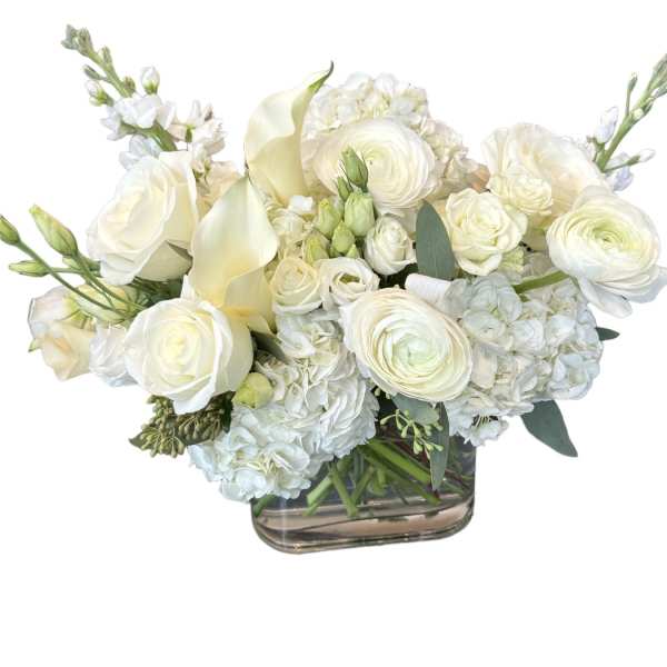 White roses, calla lilies, and hydrangeas in a glass vase