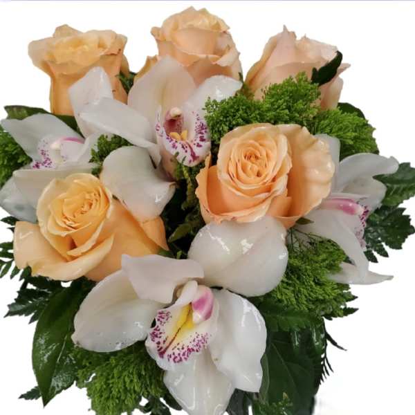 Peach roses and white orchids in a compact bouquet