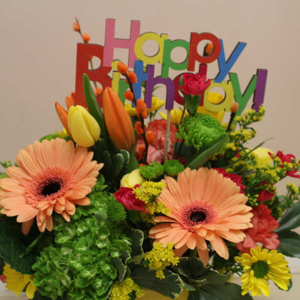 Colorful birthday bouquet with gerbera daisies and tulips