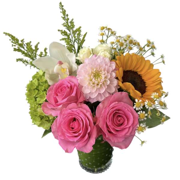 Bouquet of pink roses, a sunflower, and mixed white blooms in a glass vase