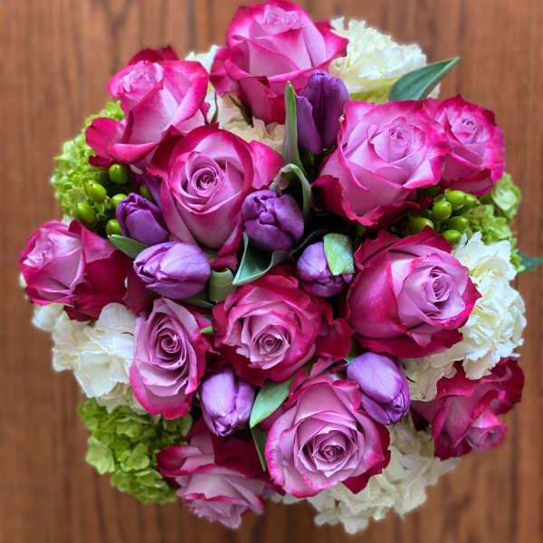 Bouquet of pink roses and purple tulips with white blooms