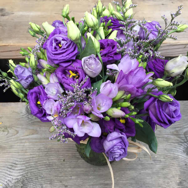 Purple and lavender bouquet with lisianthus in a vase