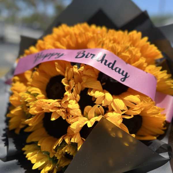 Yellow flower bouquet with a pink Happy Birthday ribbon