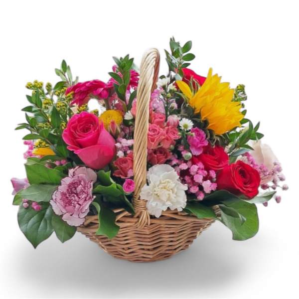 Colorful mixed flower basket with roses and carnations in a wicker basket
