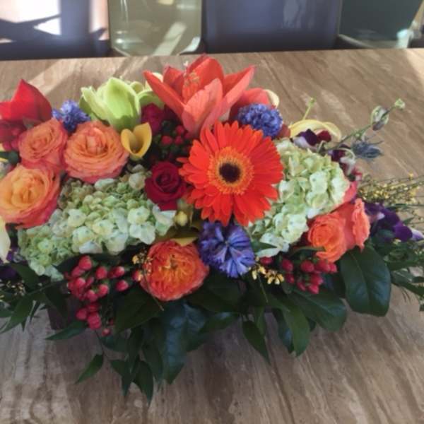 Colorful mixed flower arrangement with gerbera daisies, roses, and lilies