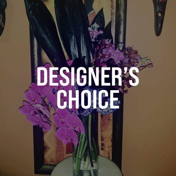 Purple orchid arrangement in a glass vase with designer's choice text