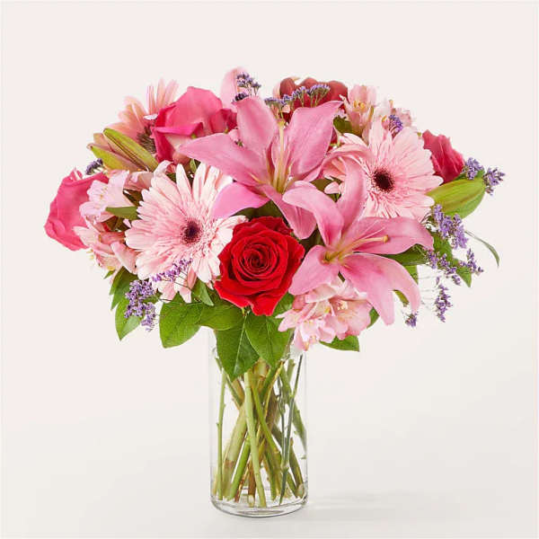Pink mixed flower bouquet in a clear glass vase