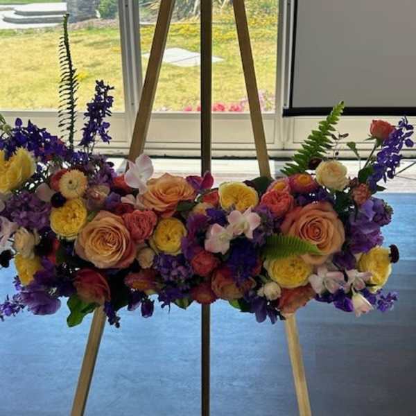 Colorful floral spray on a wooden easel