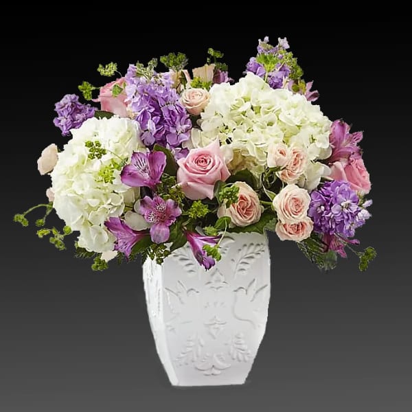 Pink and purple mixed bouquet in a white vase
