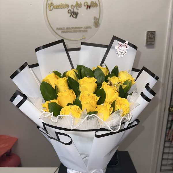 Yellow roses, each one bearing its own diamond, metal butterfly, pearl ribbon, white paper