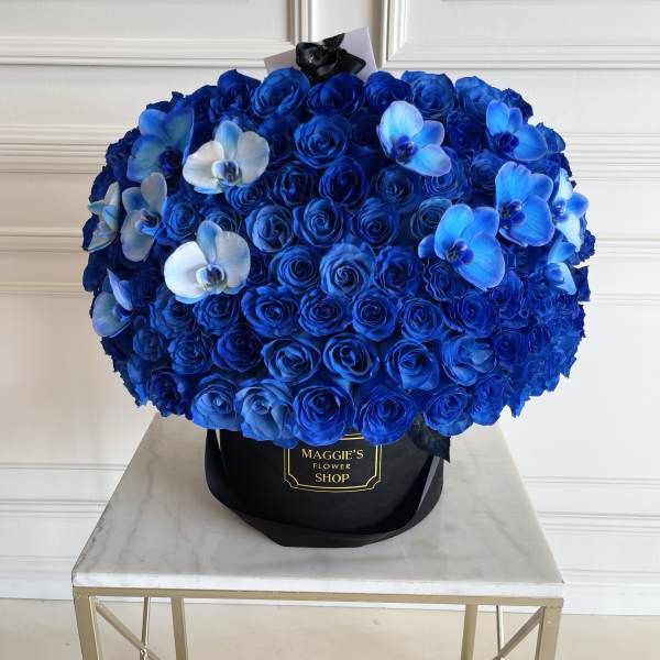 Blue rose bouquet with white and blue orchids in a black hat box