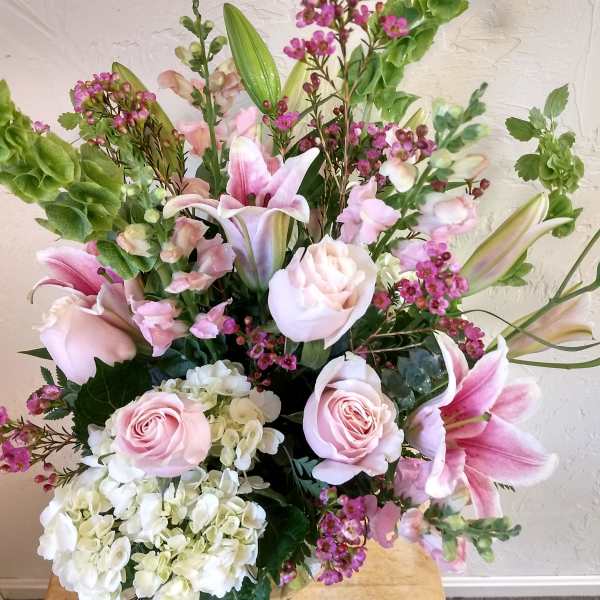 Pink roses, lilies, and white hydrangeas in a mixed bouquet