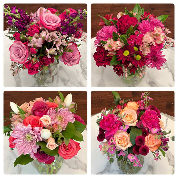 Four colorful mixed bouquets in glass vases on a marble surface