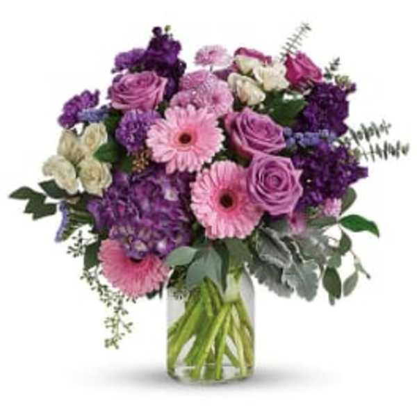 Pink and purple mixed bouquet in a clear glass vase