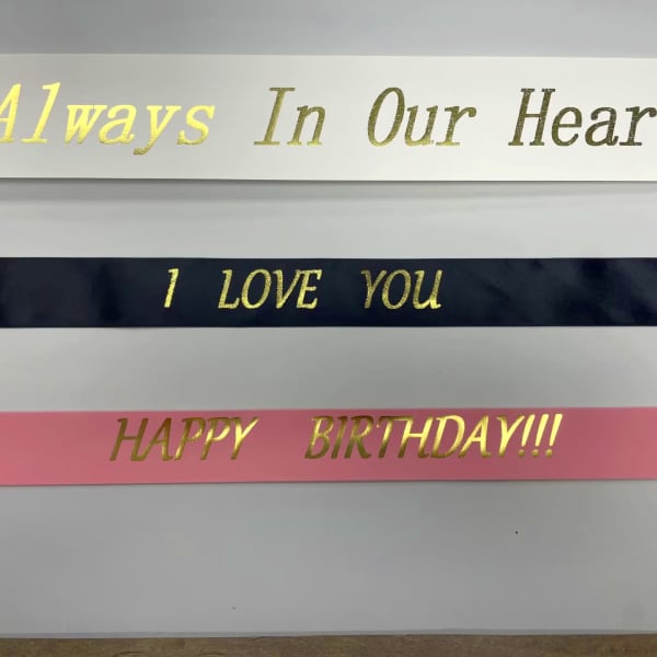 Decorative ribbons with gold lettering reading "I LOVE YOU" and "HAPPY BIRTHDAY!!!"