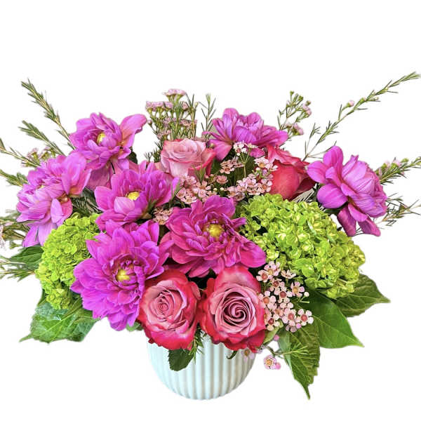Pink and magenta flowers arranged in a ribbed white vase
