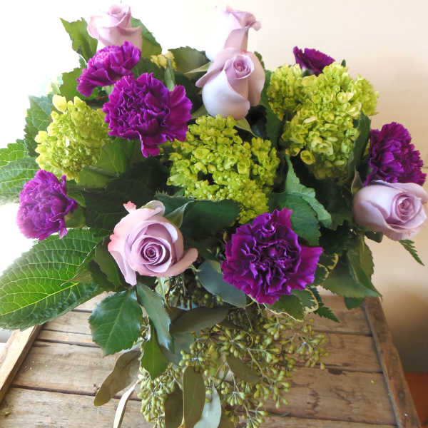 Bouquet of lavender roses, purple carnations, and green hydrangeas