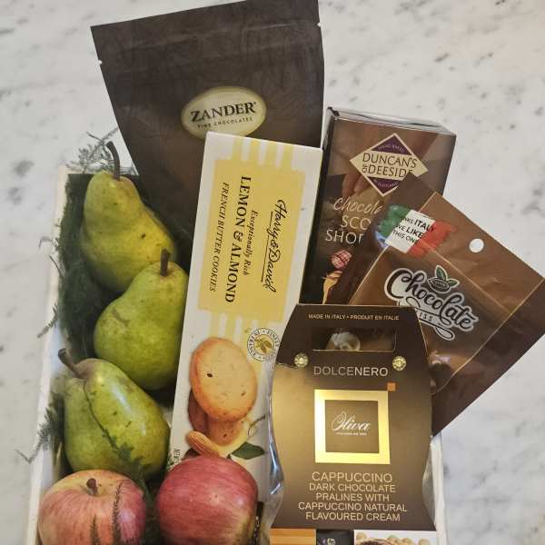 Gift tray with pears, apples, and assorted chocolate boxes